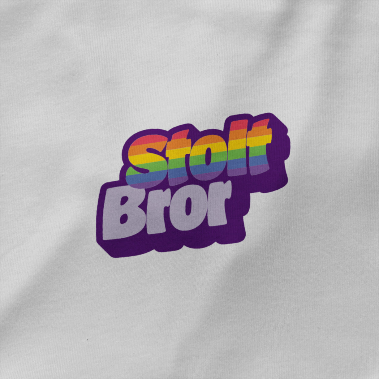 Hvit unisex T‑skjorte med teksten ‘Stolt bror’ i regnbuefarger – enkel rund hals, single jersey og inkluderende Pride-design. nærbilde